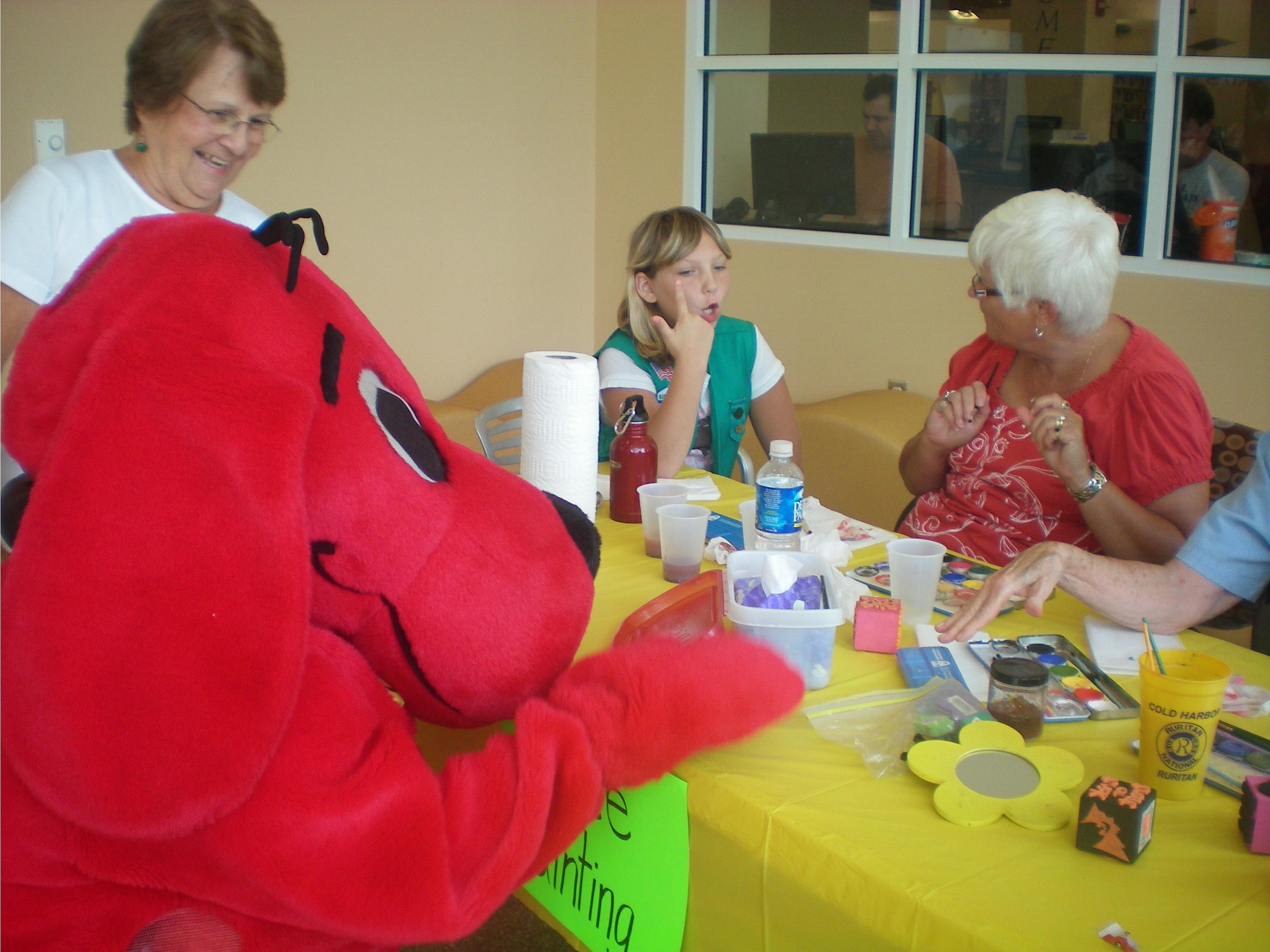 Clifford the Big Red Dog visited the face-painting station during the Pamunkey Library's annual Back to School Celebration for preschoolers. A school bus is on-site during the program and the little kids love to get on board for the first time and ride around the library.